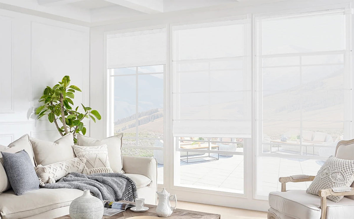 Sheer Roman shades filtering sunlight in a living room