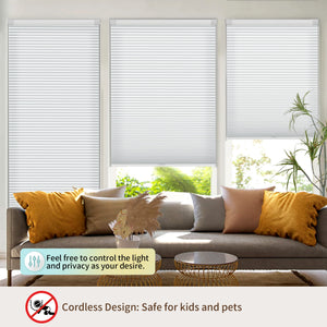 Light gray no-drill cellular honeycomb shade: above a window seat