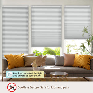 Gray no-drill cellular honeycomb shade: above a window seat