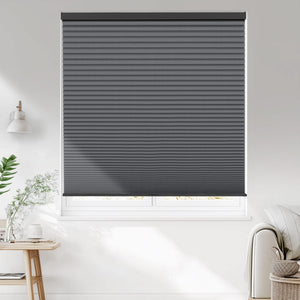 Dark gray cellular honeycomb shade: on a window