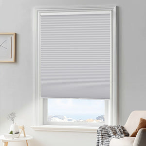 Gray cellular honeycomb shade: in a furnished room