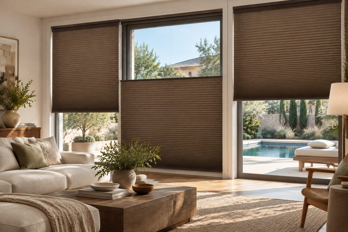 Brown top-down bottom-up shades adjusted to different heights on living room windows overlooking a pool.