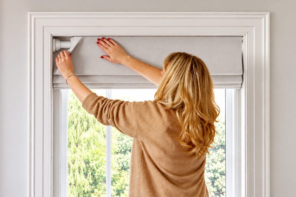 Installing a tension-mounted no-drill Roman shade inside a window frame
