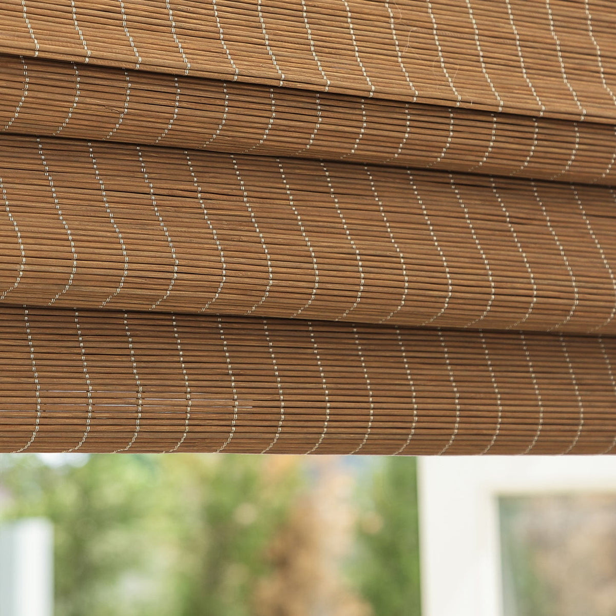 Natural brown bamboo Roman shade: folded fabric close-up