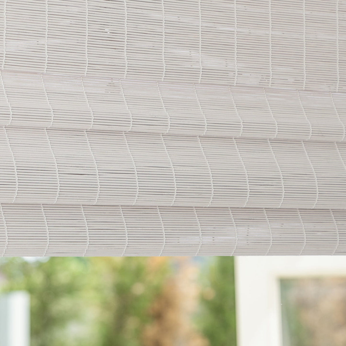 White bamboo Roman shade: folded fabric close-up