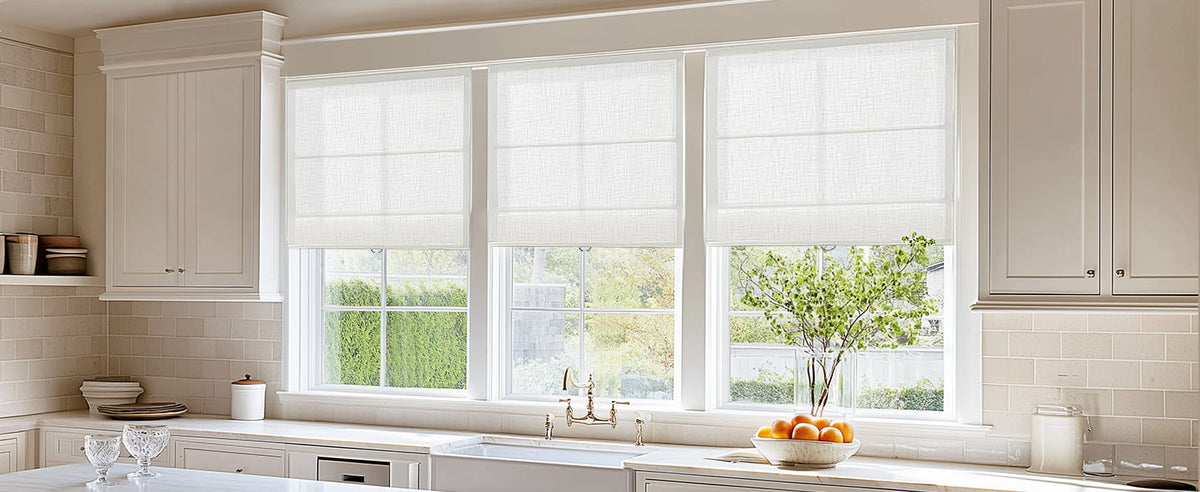 White Roman shades above a kitchen counter