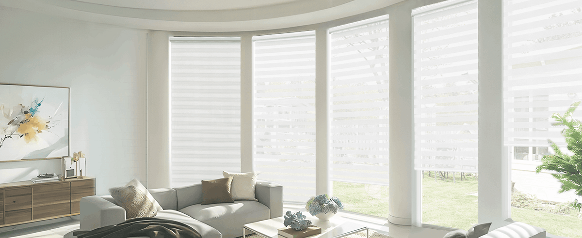 White zebra blinds on living room bay windows