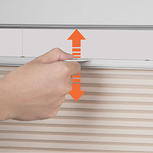 Hand lifting a cordless cellular shade using the bottom rail handle