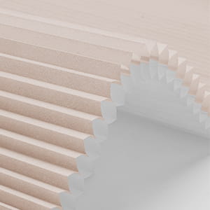 Cellular shade fabric curved to reveal its honeycomb cells