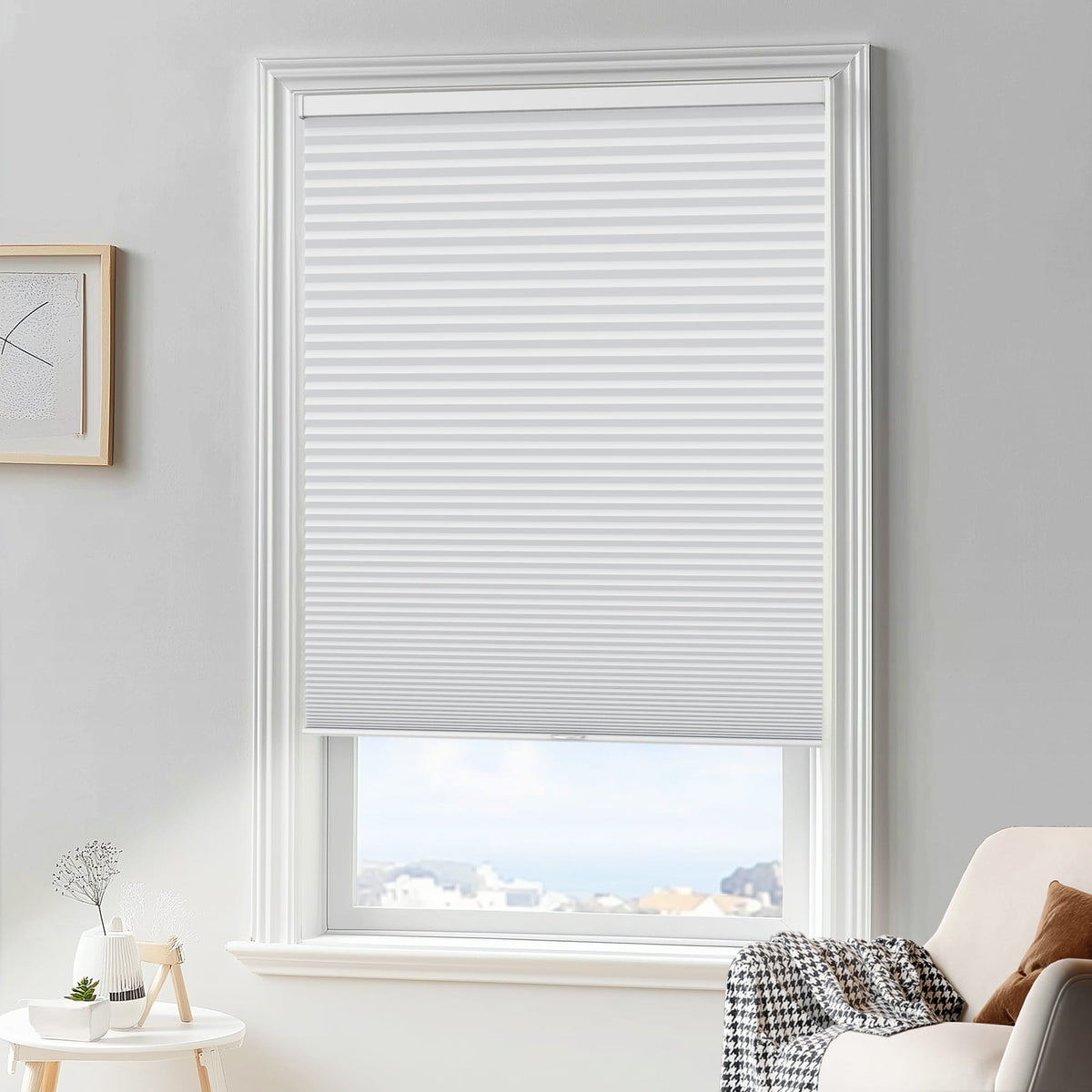 White cellular honeycomb shade: in a furnished room