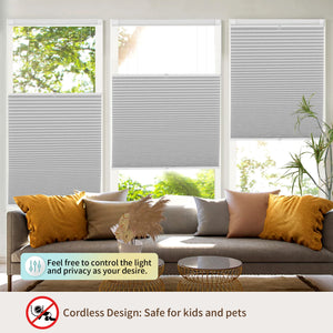 Light gray top-down bottom-up no-drill cellular honeycomb shade: above a window seat