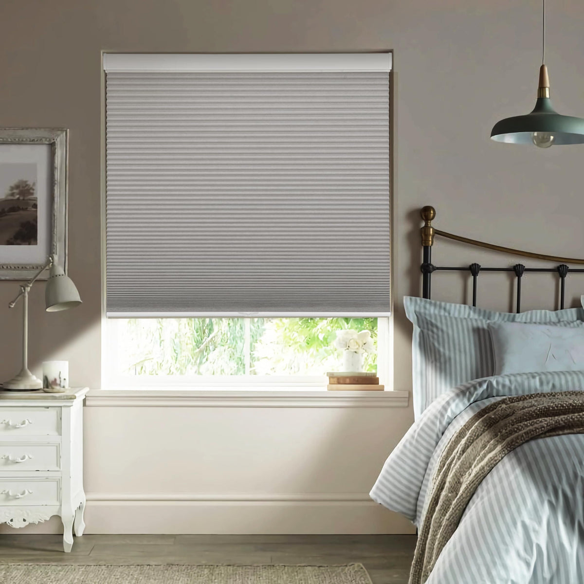 Gray cellular honeycomb shade: in a bedroom