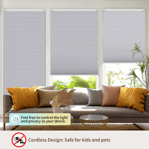 Gray no-drill cellular honeycomb shade: above a window seat