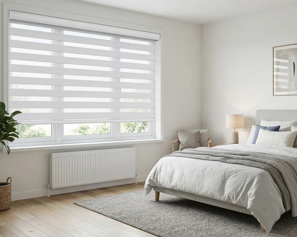 White zebra shades in a bright modern bedroom with adjustable light-filtering bands