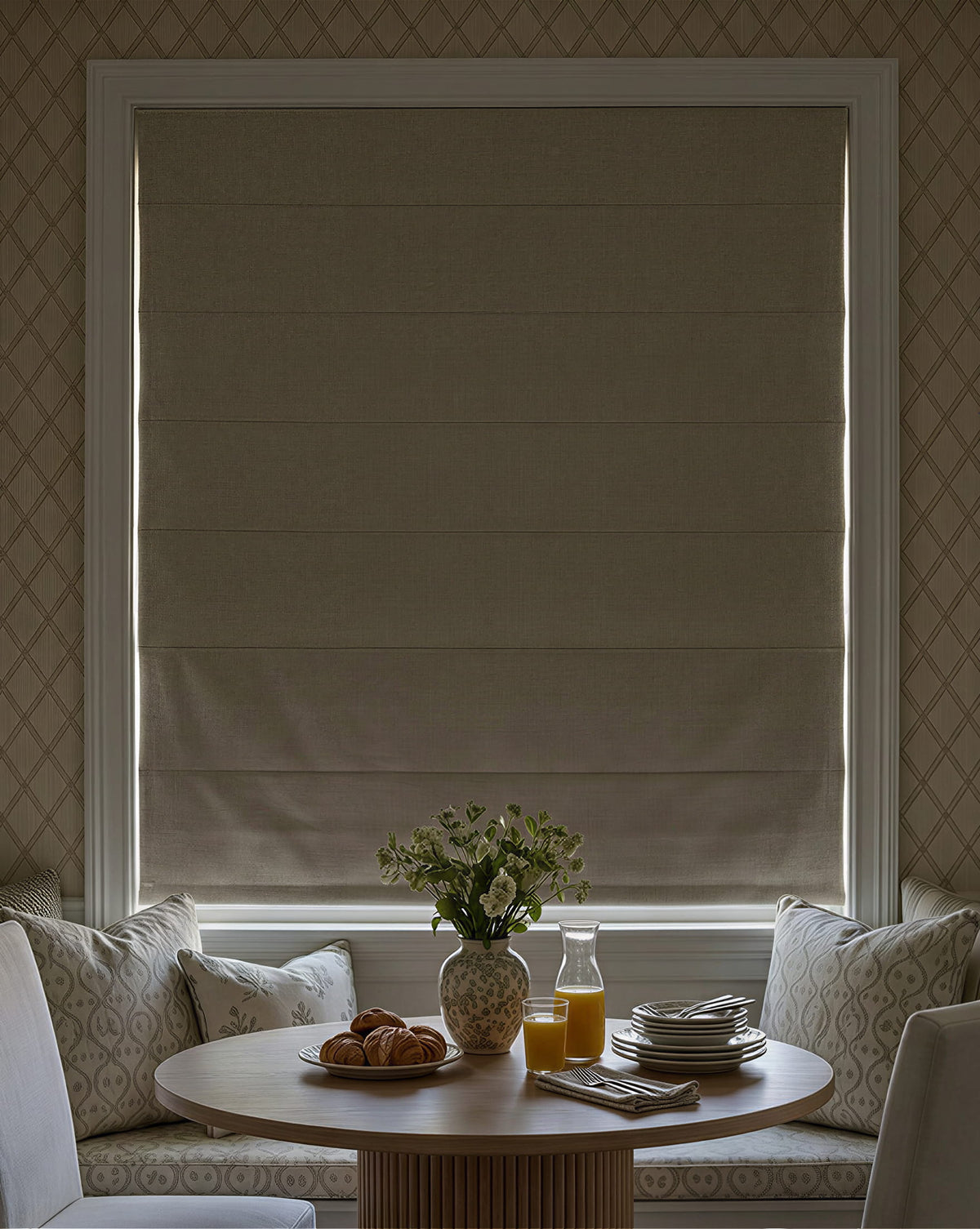 Darkened Roman shade above a small dining table