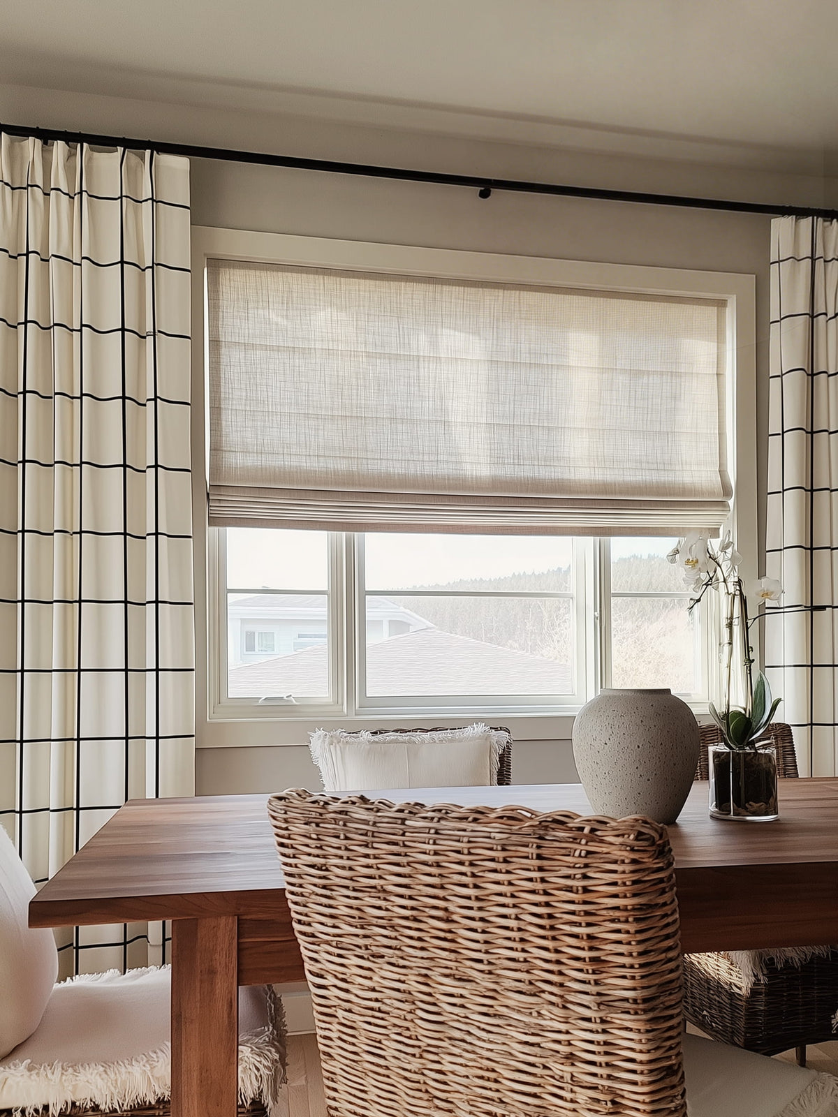 Flat Roman shade above a wooden dining table
