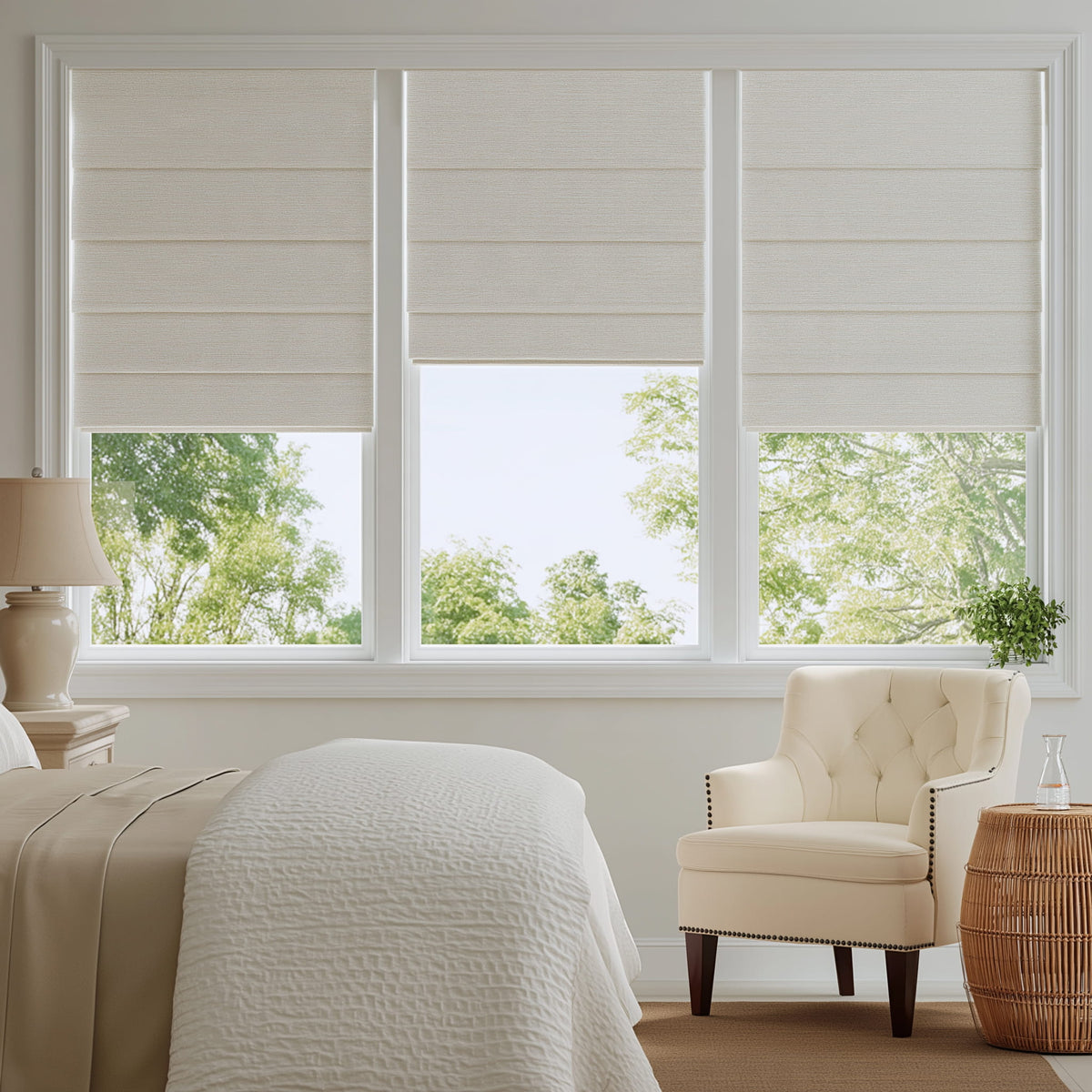 White Roman shades in a bright bedroom